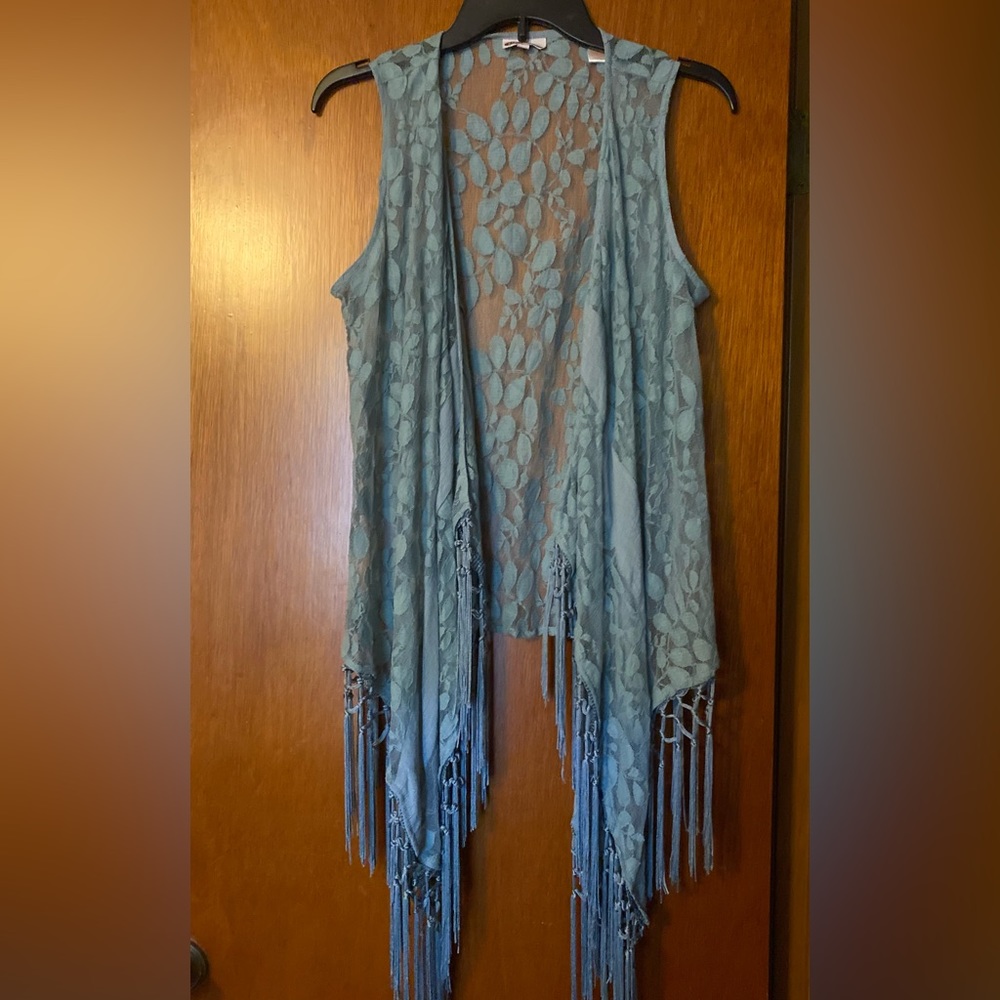 Lace vest with fringe.
